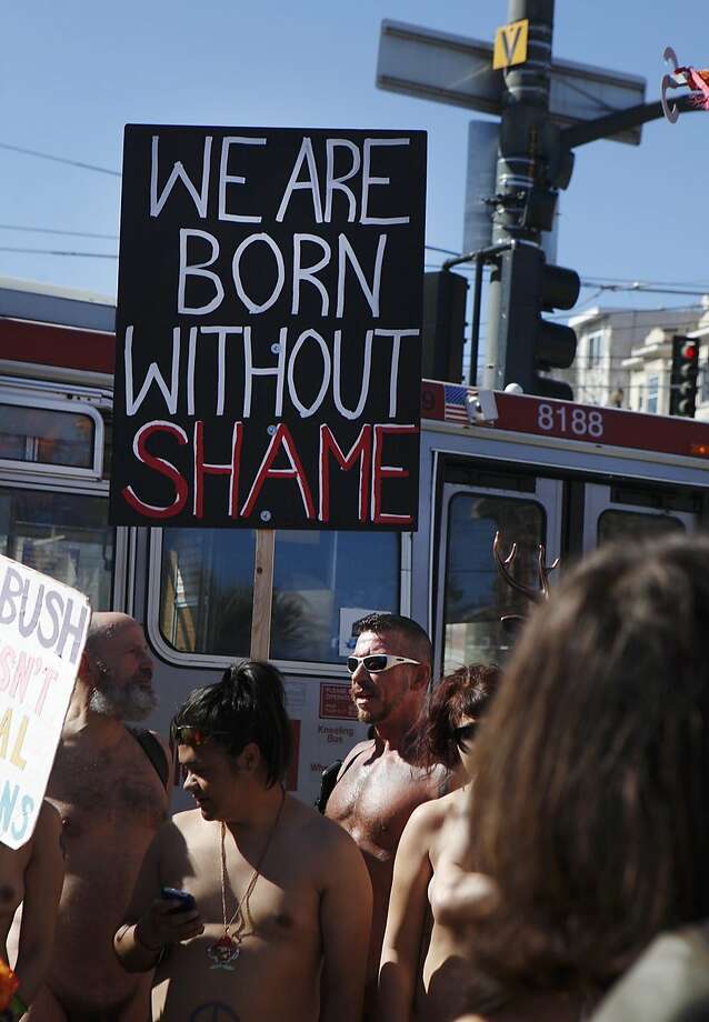 Ray Dalton holds a sign reading 'We Are Born Without Shame' during the first annual Valentine's Nude Parade put together by the Body Freedom Network, in San Francisco, Calif., on Saturday Feb. 13, 2016 Photo: Brittany Murphy, The Chronicle
