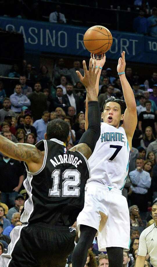 Charlotte Hornets guard Jeremy Lin shoots the ball over San Antonio Spurs forward LaMarcus Aldridge during Monday night's game at Time Warner Cable Arena on March 21, 2016 in Charlotte, N.C. The Charlotte Hornets defeated the San Antonio Spurs 91-88. Photo: Robert Lahser, TNS / Charlotte Observer