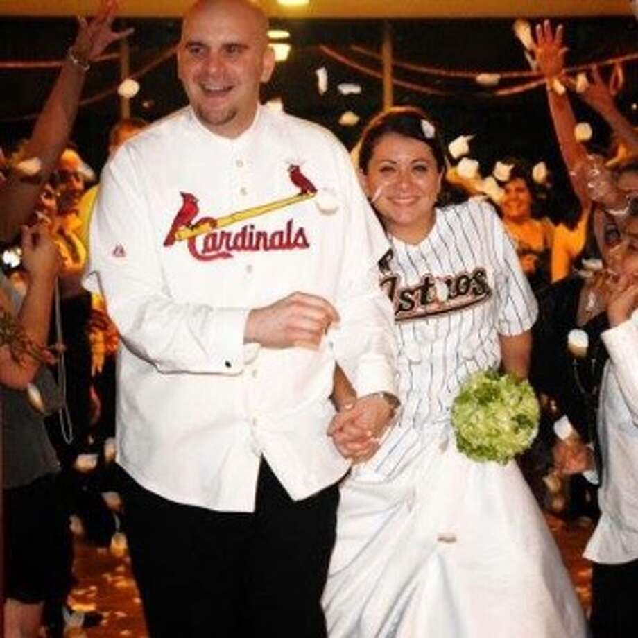 Mike Dawid, a devout Cardinals fan, and wife Ellie, who prefers the Astros, showed their fandom on their wedding day, and later, each snagged a home-run ball at a game on their anniversary.