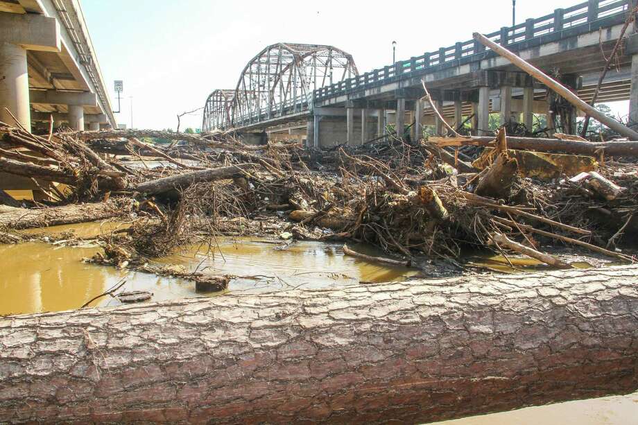Flood debris clogs the San Jacinto River West Fork channel and what once was a boat ramp beneath the Highway 59 bridge﻿. Photo: Shannon Tompkins