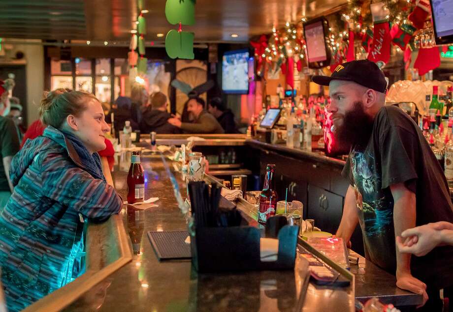 Bartender Ryan Sherman, above, talks with Tea Smith at the Mix in S.F. Left: Customers have drinks in a festive atmosphere. Photo: John Storey, Special To The Chronicle