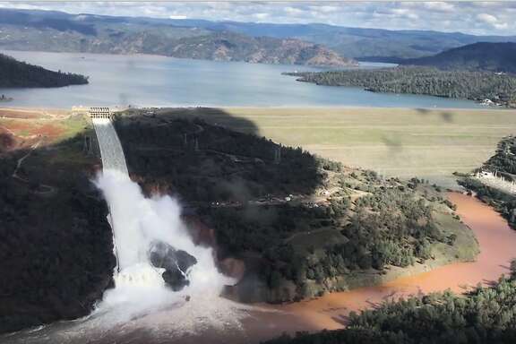 This Friday, Feb. 10, 2017 image from video provided by the office of Assemblyman Brian Dahle shows water flowing over an emergency spillway of the Oroville Dam in Oroville, Calif., during a helicopter tour by the Butte County Sheriff's office. About 150 miles northeast of San Francisco, Lake Oroville is one of California�s largest man-made lakes, and the 770-foot-tall Oroville Dam is the nation's tallest. (Josh F.W. Cook/Office of Assemblyman Brian Dahle via AP)