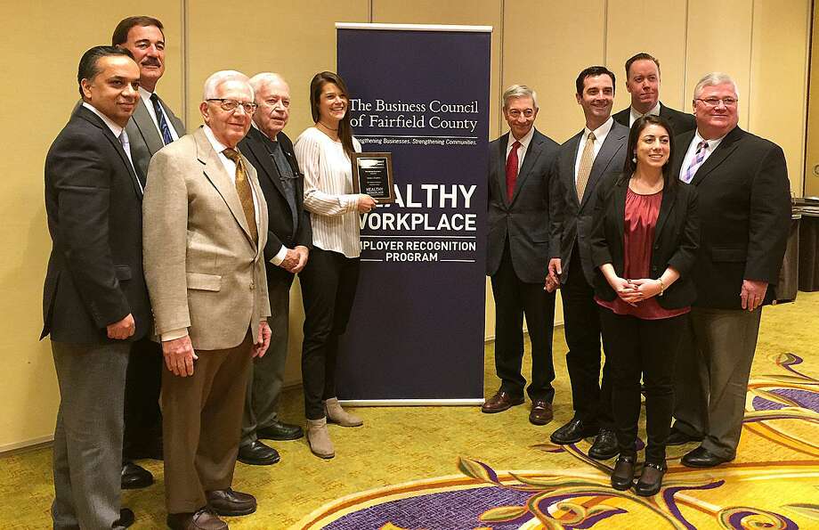 Grade A Markets team members John Kapoor, Jack SantaMaria, Sam Cingari, Rocky Cingari, Cora Ragaini, Chip Cingari, Dominick Cingari, Jenna Hourani, Darren Powers and Dave Roche celebrate receiving a Innovation Award at the Business Council of Fairfield County's Workplace Wellness Program ceremony in Stamford on Feb. 14. Photo: Contributed Photo / The News-Times Contributed