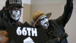 Leonard Quinones (right), a member of the Black Hole fan club, joins other diehard Oakland Raiders fans to listen as Mayor Libby Schaaf details a new football stadium plan at a news conference and rally at the Coliseum in Oakland, Calif. on Saturday, March 25, 2017, in a last ditch effort to convince NFL owners to vote down a proposal to relocate the Raiders to Las Vegas.