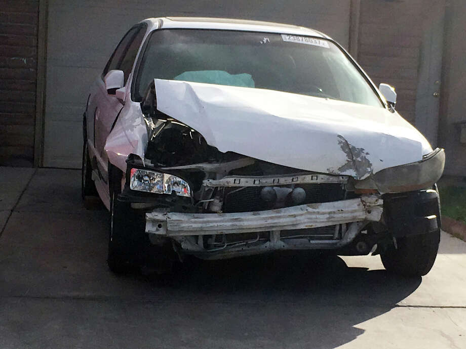 In this Tuesday, April 18, 2017, photo, a 2002 Honda Accord involved in a March 3, 2017, crash in which an exploding Takata air bag inflator badly injured the driver, Karina Dorado, sits in a driveway in Las Vegas. The incident has exposed a danger posed by the recalled parts. Nothing prevents the reuse of air bags from older models to fix wrecked cars that can then be resold, often to unsuspecting buyers. (AP Photo/Ken Ritter) ORG XMIT: NYBZ304 Photo: Ken Ritter / Copyright 2017 The Associated Press. All rights reserved.