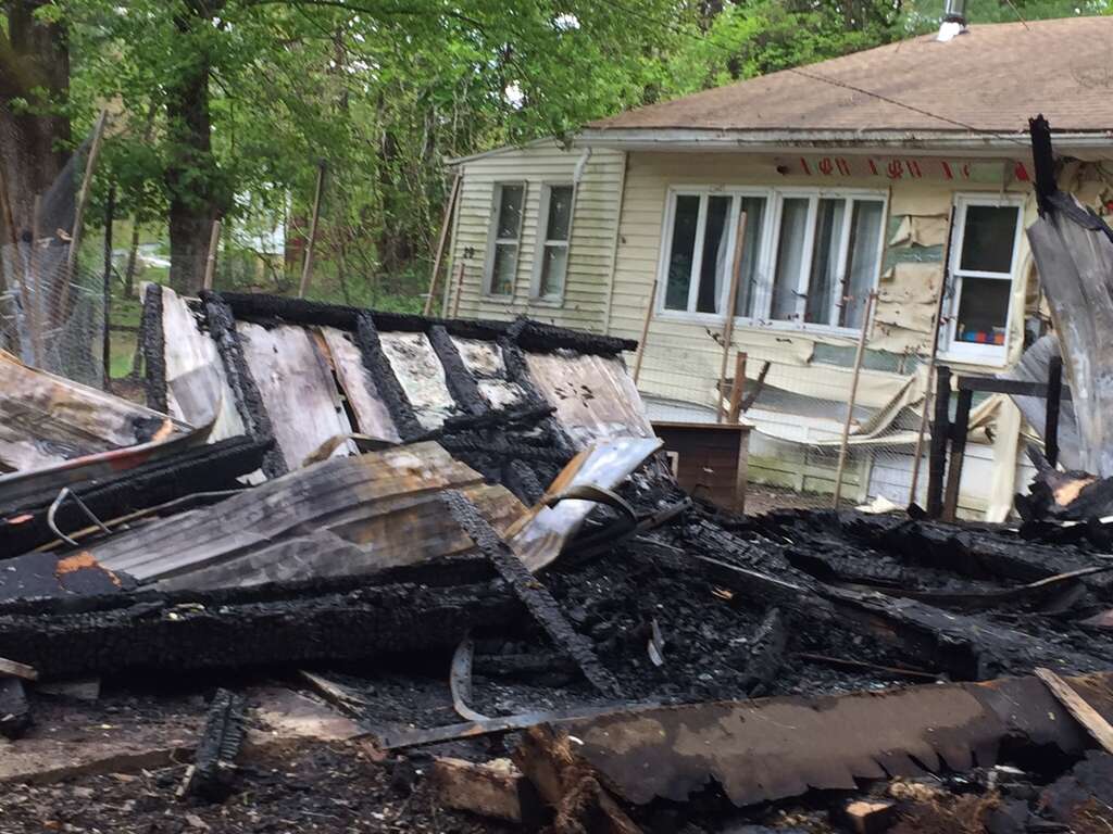 A black family woke up Sunday night to find their detached garage sprayed with hateful graffiti and engulfed in flames, Schodack Police Chief Joseph Belardo said Monday, May 15, 2017. The parents and their five children — who are all under the age of 10 — were physically unharmed but emotionally traumatized by the fire set at 29 Cold Spring Ave., the chief said. (Robert M. Gavin/Times Union) Photo: Robert Gavin
