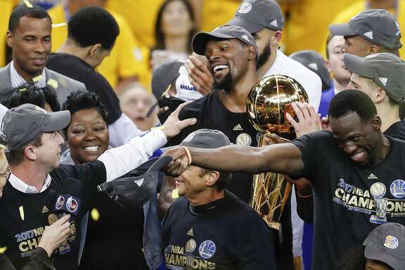 Golden State Warriors' Kevin Durant holds the the Larry O�Brien NBA Championship Trophy after the Golden State Warriors defeated the Cleveland Cavaliers 129-120 in Game 5 to win the 2017 NBA Finals at Oracle Arena on Monday, June 12, 2017 in Oakland, Calif.