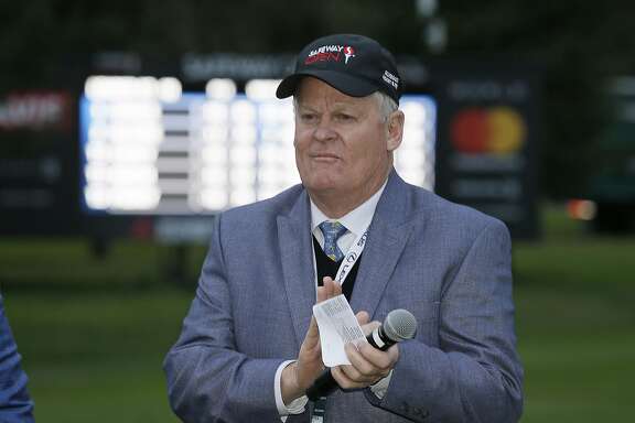 FILE - In this Oct. 16, 2016, file photo, Johnny Miller stands on the 18th green of the Silverado Resort North Course during the trophy presentation of the Safeway Open PGA golf tournament, in Napa, Calif. Television viewers haven't heard the last of Johnny Miller just yet. Miller says he thought this might be his final year in the broadcast booth for NBC Sports so he could spend more time with his 23 grandchildren. But in a telephone interview Monday, July 10, 2017, he said he will stick around for at least another year. This is his 28th year working for NBC.(AP Photo/Eric Risberg, File)