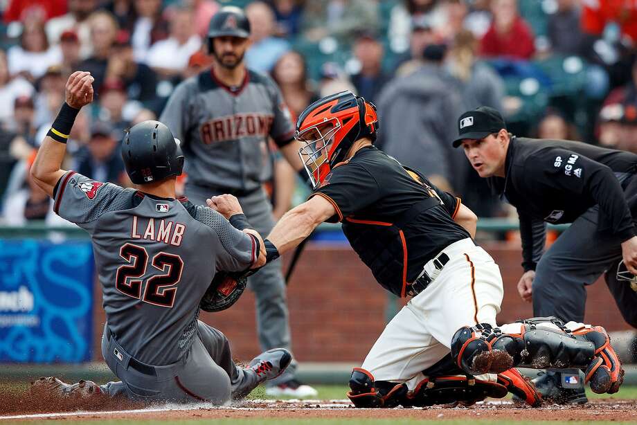 SAN FRANCISCO, CA - AUGUST 05: Jake Lamb #22 of the Arizona Diamondbacks is tagged out at home plate by Nick Hundley #5 of the San Francisco Giants during the first inning at AT&T Park on August 5, 2017 in San Francisco, California.  (Photo by Jason O. Watson/Getty Images) Photo: Jason O. Watson, Getty Images