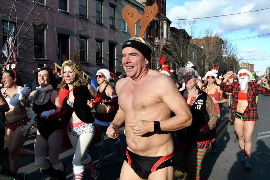 Race participants run for the finish line during the 11th annual Santa Speedo Sprint on Saturday, Dec. 10, 2016, on Lark Street in Albany, N.Y. The 800-meter run, organized by the Albany Society for the Advancement of Philanthropy, raises funds for the Albany Damien Center and HIV/AIDS program at Albany Medical Center. (Cindy Schultz / Times Union) Photo: Cindy Schultz / Albany Times Union