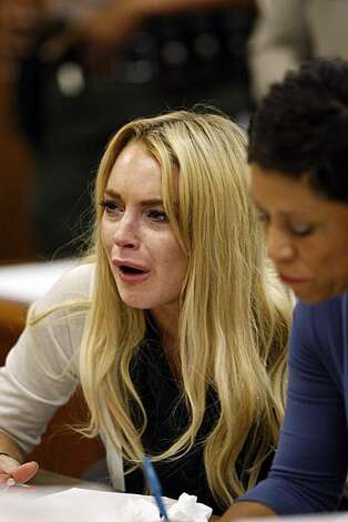 Blonde Lindsay Lohan looking upset in court