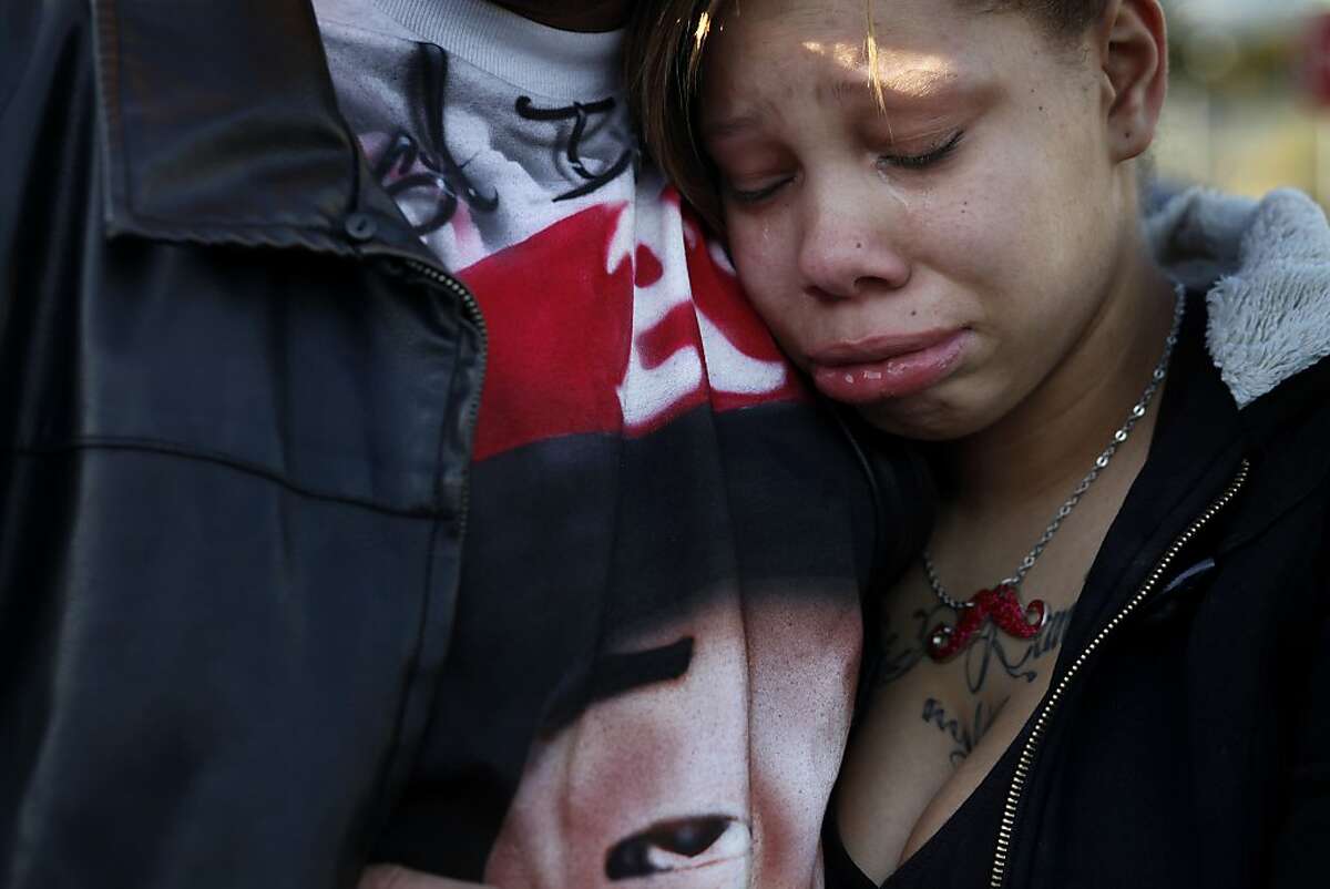 Brijjanna Price, 17, is comforted by her father during the vigil marking the one year anniversary of her brother Lamont's killing, Saturday February 16, 2013, in Oakland, Calif. Lamont Price, 17, was one of the 131 homicides in 2012. Photo: Lacy Atkins, The Chronicle