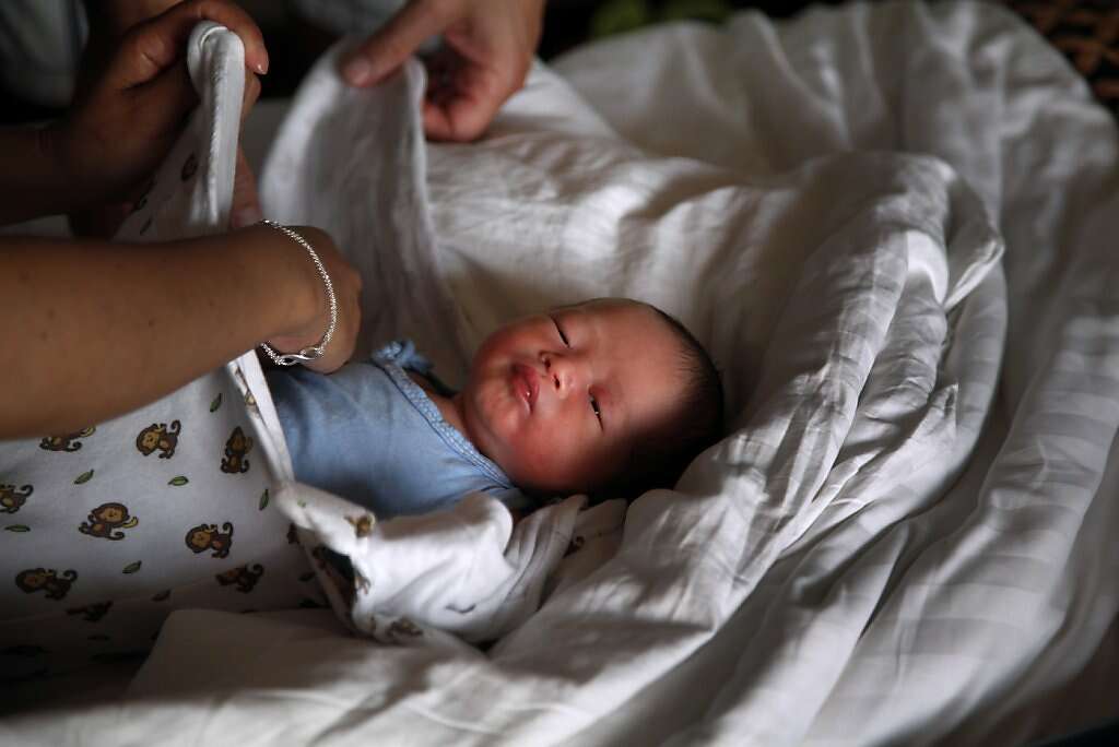Jennifer Benito-Kowalski and Steve Kowalski swaddle baby Kyle in their room at the Madhubhan Resort and Spa in Anand, India, Friday, May 24, 2013. Photo: Nicole Fruge, The Chronicle