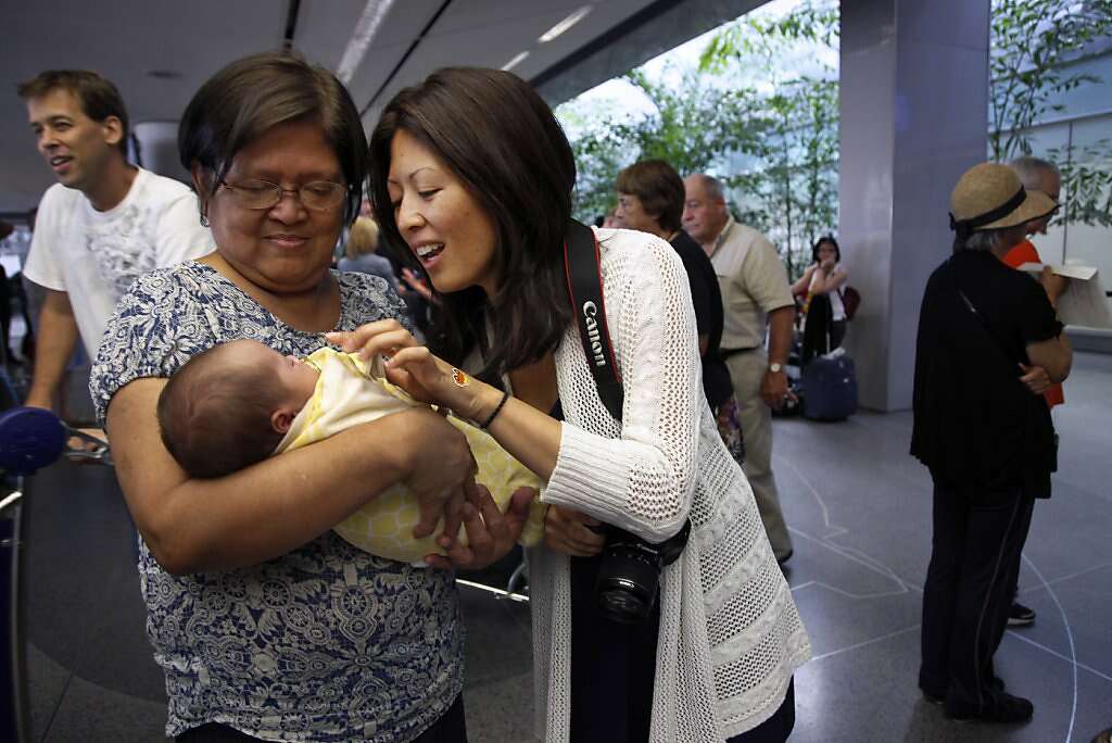 Jennifer Benito-Kowalski's mother, Clemencia "Amy" Benito (left) and sister Lourdes Benito-Goodall meet baby Kyle for the first time at San Francisco International Airport, Saturday, June 15, 2013. Photo: Nicole Fruge, The Chronicle