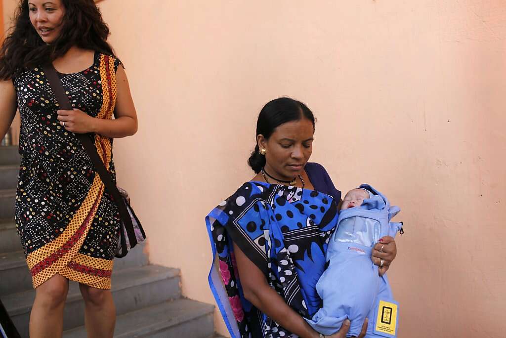 A pediatrician's helper, Tiupi Dave, carries baby Kyle Benito Kowalski down the operating room stairs to a waiting car as his mom Jennifer Benito-Kowalski follows behind at the Akanksha Infertility Clinic in Anand, India, Thursday, May 23, 2013. The car travelled two blocks to the Apara Nursing Home, a hospital whose facilities included a neonatal intensive care unit. The Kowalskis had no idea where the baby was being taken until they arrived. Photo: Nicole Fruge, The Chronicle