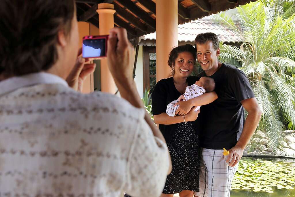 Sue Kowalski takes a family portrait of son Steve, grandson Kyle, and daughter-in-law Jennifer at the Madhubhan Resort and Spa in Anand, India, Thursday, May 30, 2013. Photo: Nicole Fruge, The Chronicle