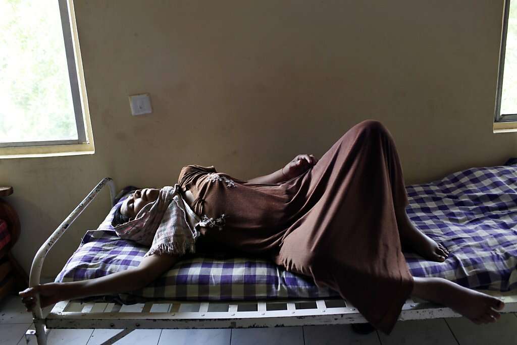 Manisha Parmar struggles with waves of pain three days after a cesarean section at the Akanksha Infertility Clinic, Sunday, May 26, 2013, in Anand, India. Photo: Nicole Fruge, The Chronicle
