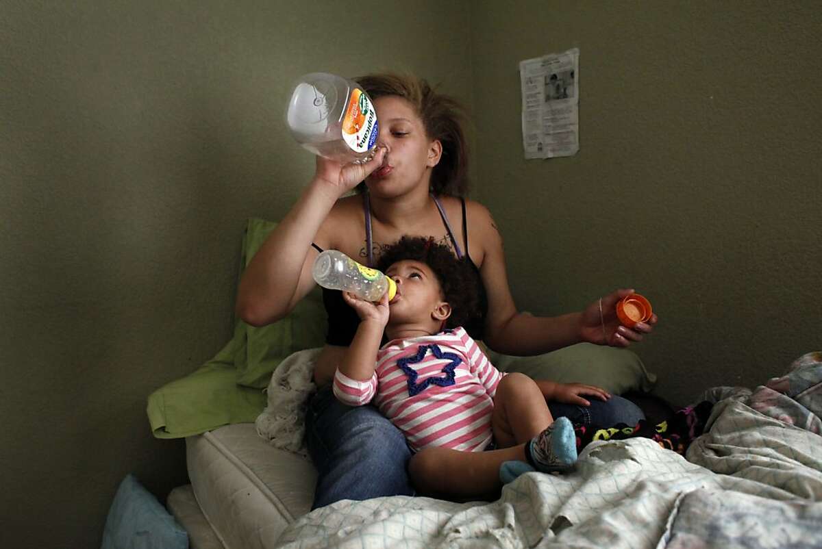 Brijjanna Price and her daughter LaMya Deshana both drink  juice while they watch television on Wednesday, November 6, 2013, in Hayward, Calif. Photo: Lacy Atkins, The Chronicle