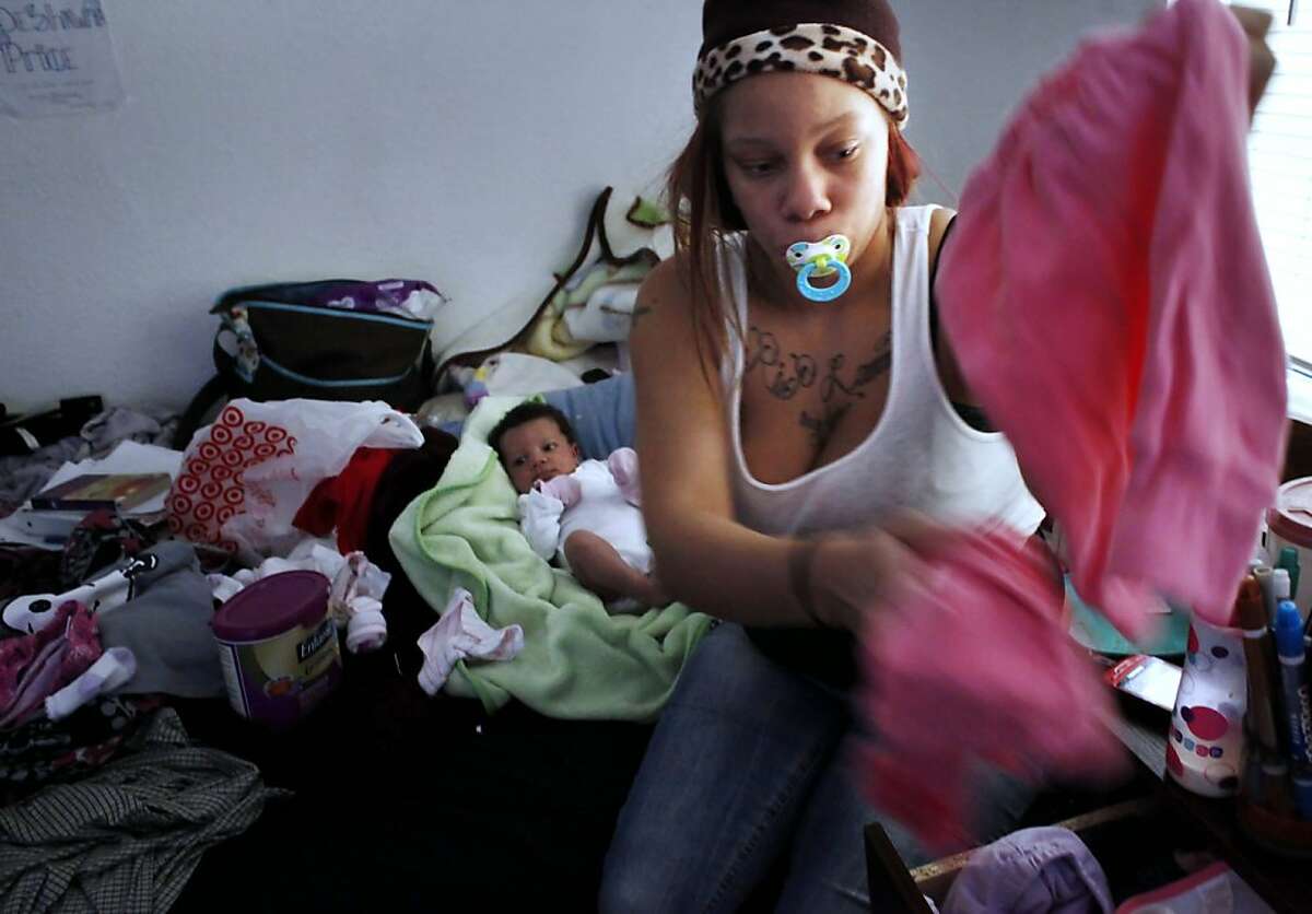 Brijjanna Price,16, cares for her newborn daughetr, La'Mya Deshana Price, Tuesday December 4 , 2012, at her godmothers house in Oakland, Calif. Photo: Lacy Atkins, The Chronicle