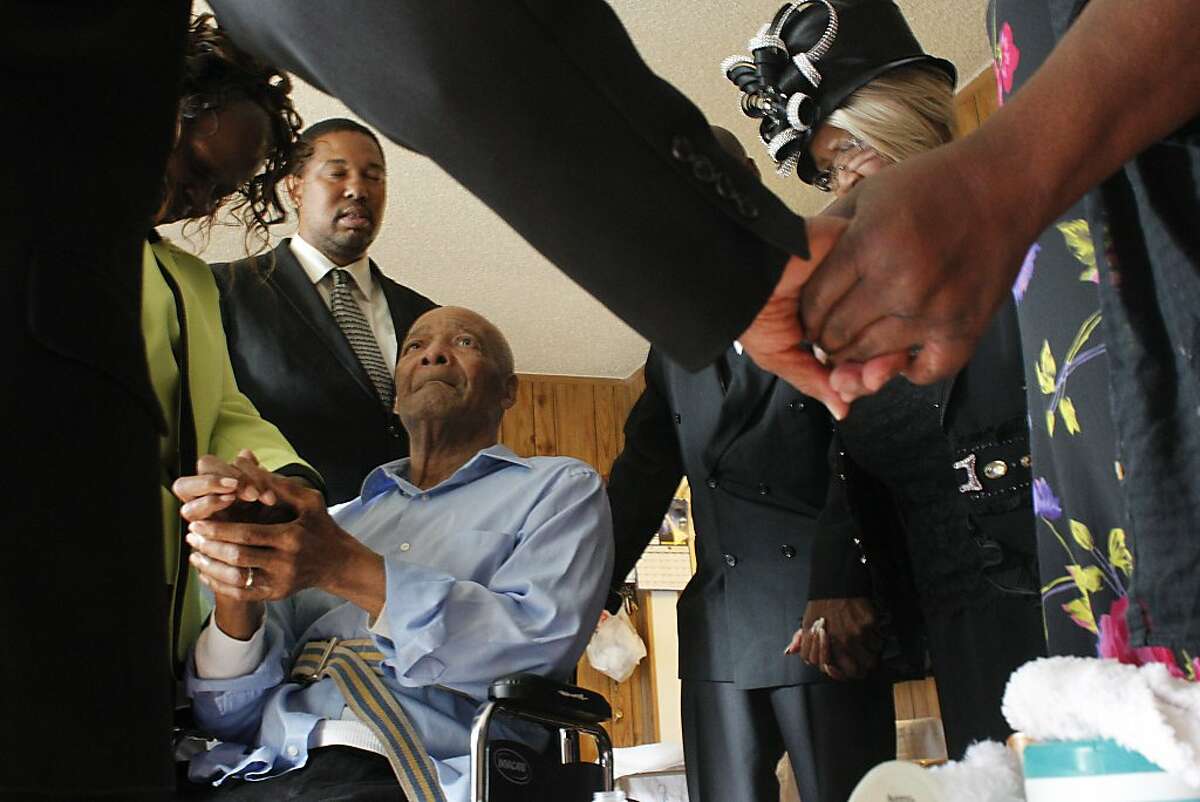 Reverend Ramon Price Sr., left, leads the Bell family is pray as they gather to go to the funeral of their grandson, Angelo Price Corbray, October 16, 2012, in Oakland, Calif. Photo: Lacy Atkins, The Chronicle