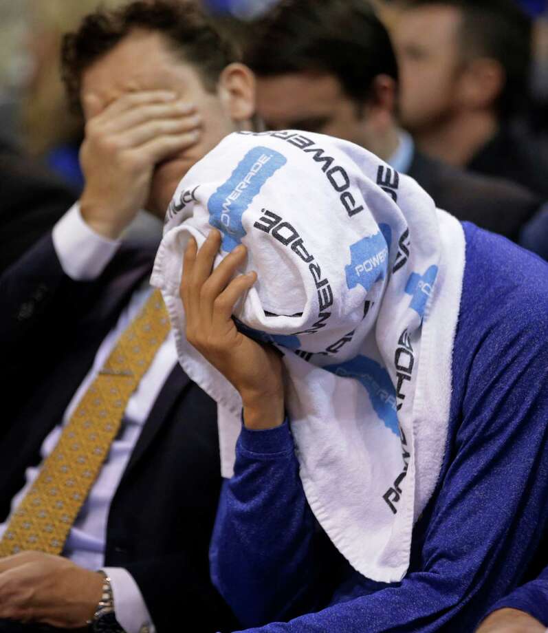 Golden State Warriors guard Stephen Curry covers his head with a towel as he sits on the bench late in the fourth quarter during the Warriors' NBA basketball game against the Utah Jazz on Friday, Jan. 30, 2015, in Salt Lake City. The Jazz won 110-100. (AP Photo/Rick Bowmer) Photo: Rick Bowmer / Associated Press / AP
