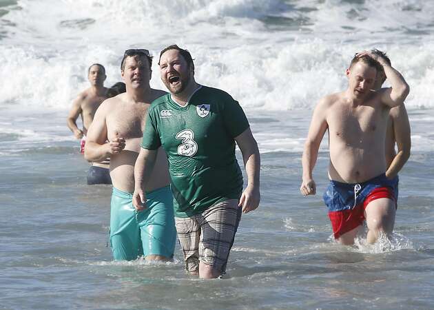 Scores brave frigid waters with New Year's Day ocean swim